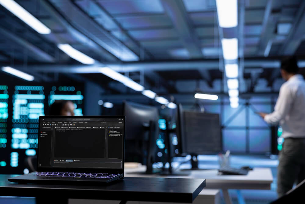 Notebook com código aberto em ambiente de TI, representando custos de desenvolvimento de software